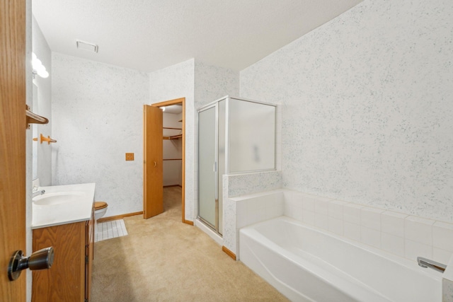 bathroom featuring shower with separate bathtub, a textured ceiling, and vanity