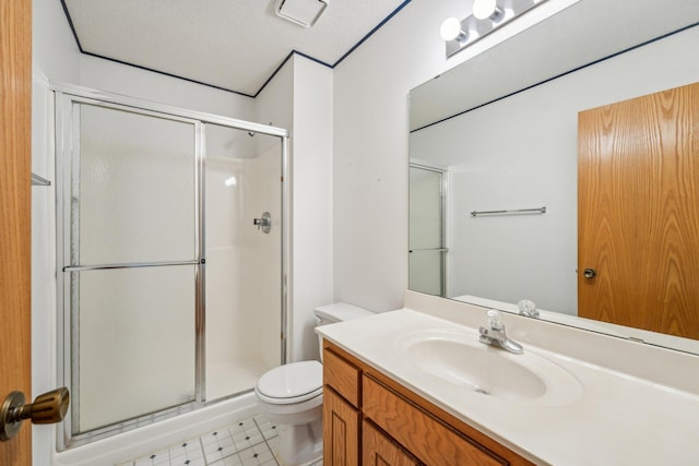 bathroom with vanity, toilet, an enclosed shower, and a textured ceiling