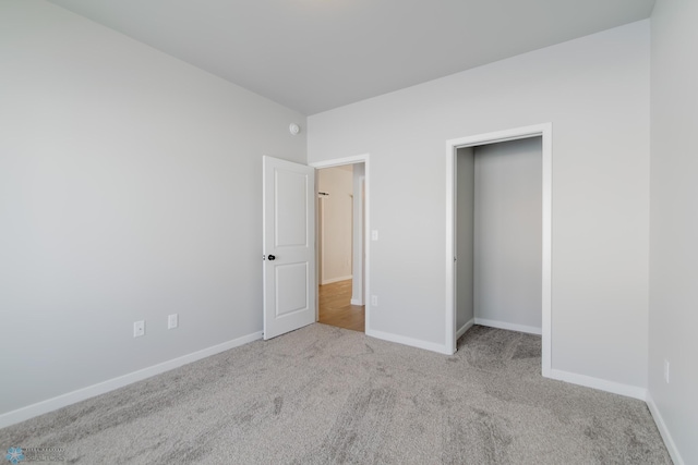 unfurnished bedroom featuring light carpet