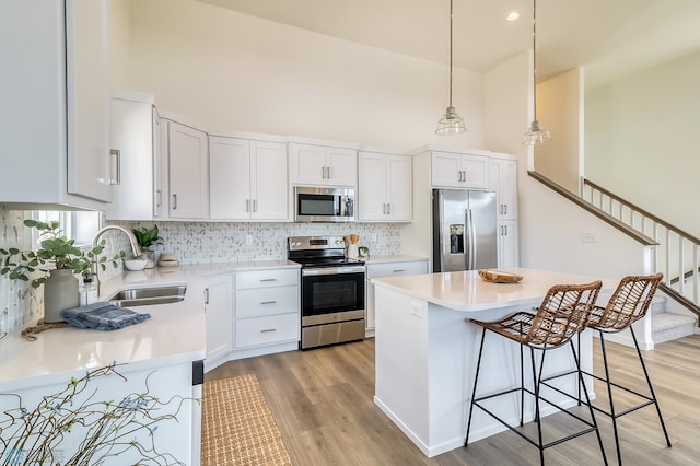 kitchen featuring white cabinetry, light hardwood / wood-style flooring, stainless steel appliances, and sink