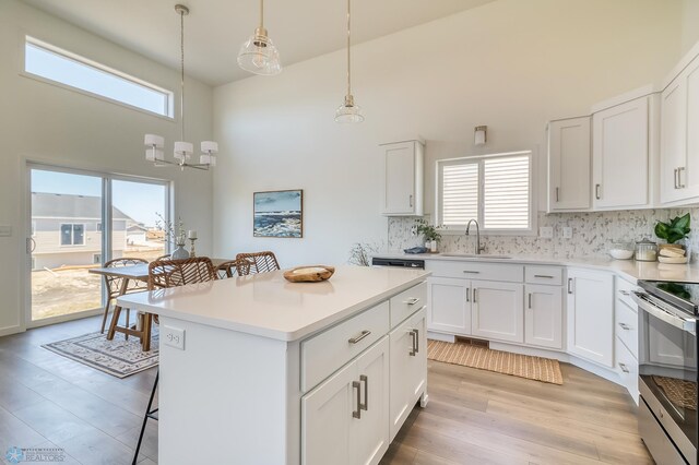 kitchen featuring white cabinetry, a healthy amount of sunlight, and a kitchen island