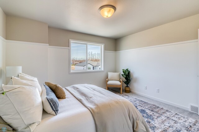 bedroom featuring light colored carpet