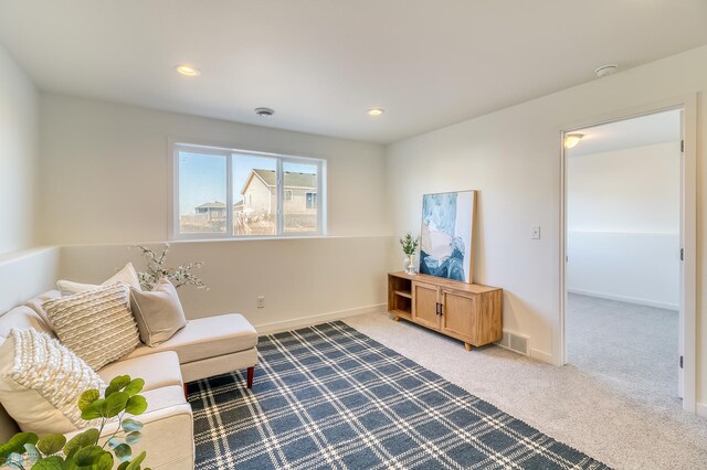 living area featuring carpet flooring