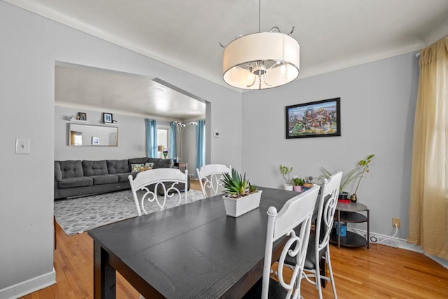 dining area featuring baseboards and wood finished floors