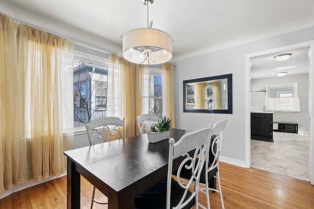 dining area featuring wood finished floors and baseboards