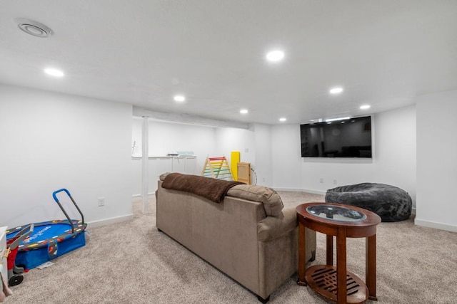 living area featuring recessed lighting, baseboards, and light colored carpet