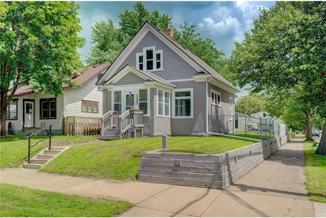 bungalow-style house featuring a front yard