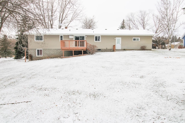 snow covered house with a deck