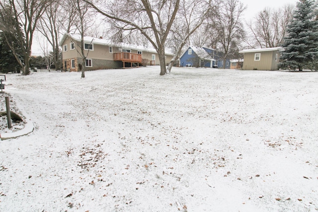 snowy yard featuring an outdoor structure