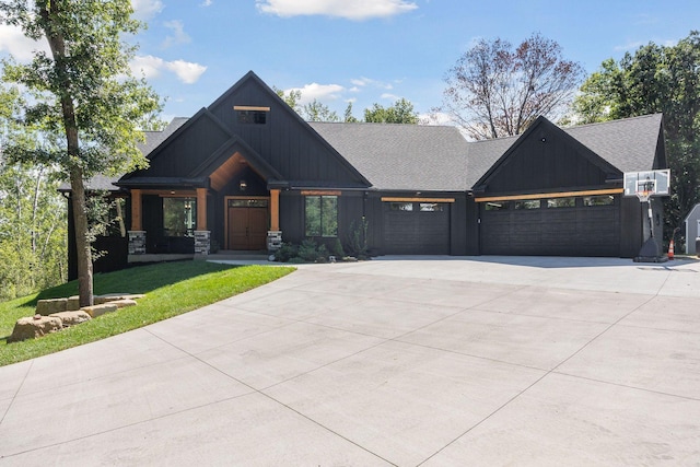 3028 Pinewood Rd SE, Rochester, MN 55904 - view of front facade with concrete driveway, an attached garage, board and batten siding, roof with shingles, and a front lawn