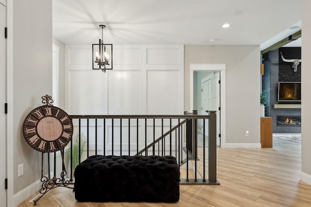 3028 Pinewood Rd SE, Rochester, MN 55904 - hall featuring baseboards, a chandelier, wood finished floors, and recessed lighting