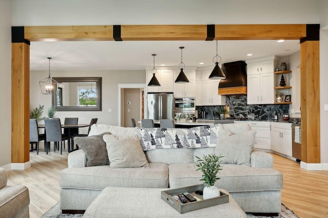 3028 Pinewood Rd SE, Rochester, MN 55904 - living room featuring light wood-style floors, beamed ceiling, baseboards, recessed lighting, and a chandelier