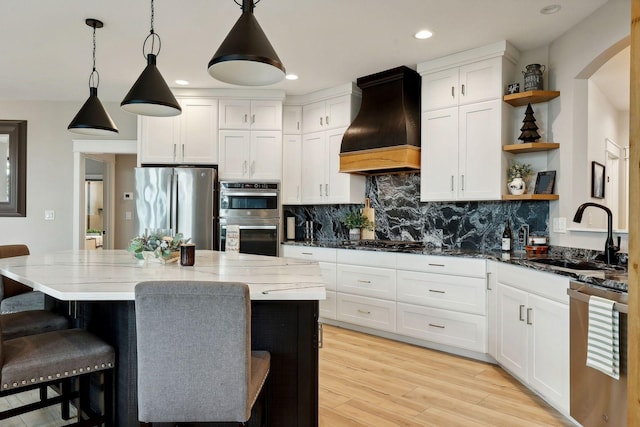 3028 Pinewood Rd SE, Rochester, MN 55904 - kitchen featuring custom range hood, open shelves, appliances with stainless steel finishes, a sink, and a breakfast bar area