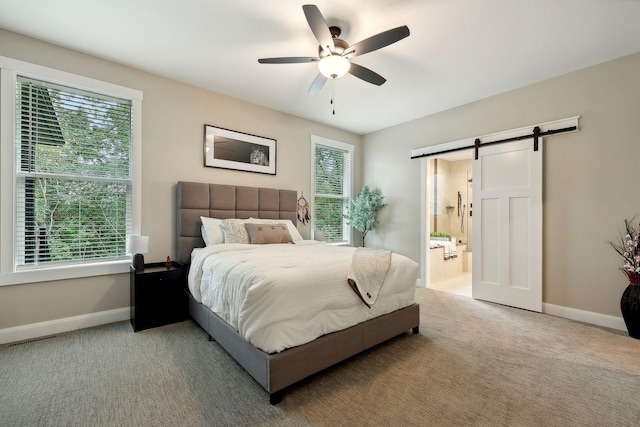 3028 Pinewood Rd SE, Rochester, MN 55904 - carpeted bedroom with a barn door, baseboards, a ceiling fan, and ensuite bathroom