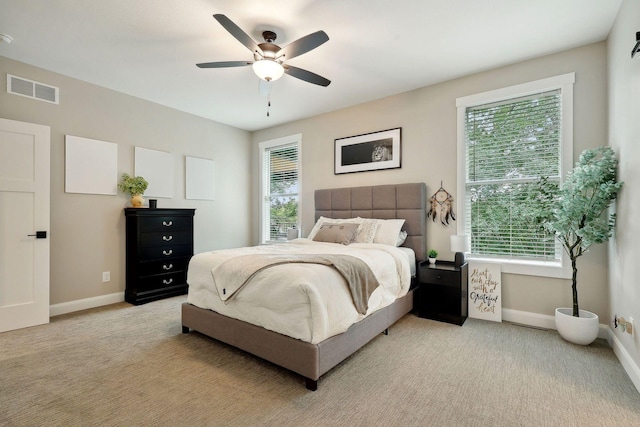 3028 Pinewood Rd SE, Rochester, MN 55904 - bedroom with light carpet, baseboards, and a ceiling fan