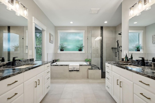 3028 Pinewood Rd SE, Rochester, MN 55904 - bathroom featuring a shower stall, plenty of natural light, tile patterned floors, a garden tub, and recessed lighting