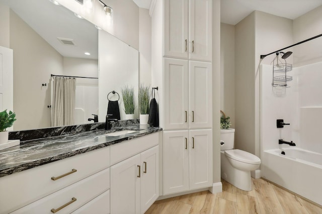 3028 Pinewood Rd SE, Rochester, MN 55904 - full bathroom with toilet, shower / tub combo with curtain, vanity, wood finished floors, and a closet