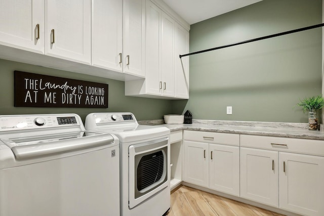 3028 Pinewood Rd SE, Rochester, MN 55904 - washroom featuring washer and clothes dryer, cabinet space, and light wood-type flooring
