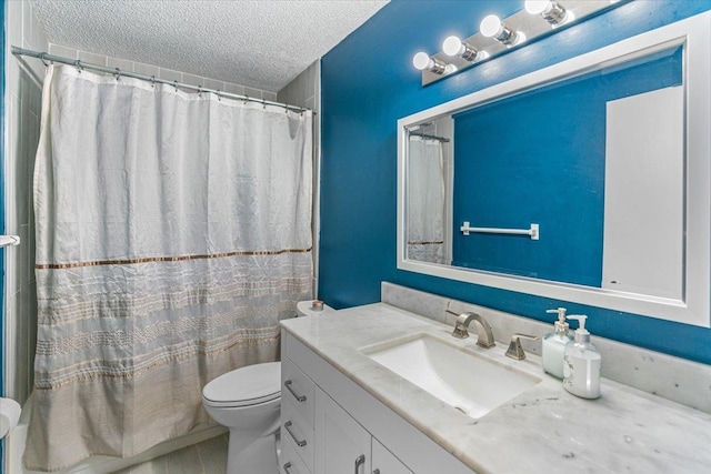 bathroom with a textured ceiling, vanity, toilet, and a shower with shower curtain