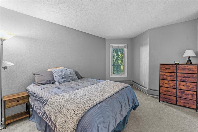 carpeted bedroom featuring a textured ceiling and a baseboard radiator