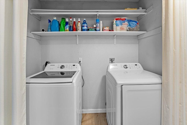 washroom featuring hardwood / wood-style flooring and washing machine and dryer