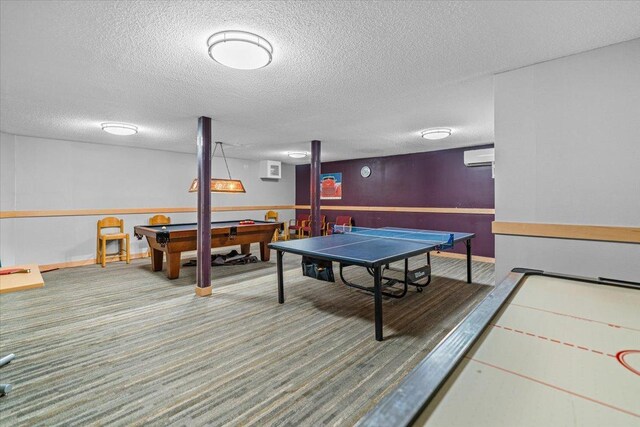 playroom featuring a wall mounted AC, a textured ceiling, billiards, and carpet floors