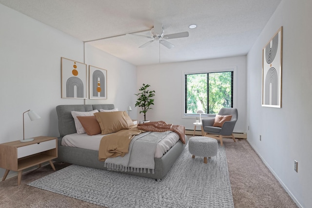 bedroom with ceiling fan, carpet floors, and a textured ceiling