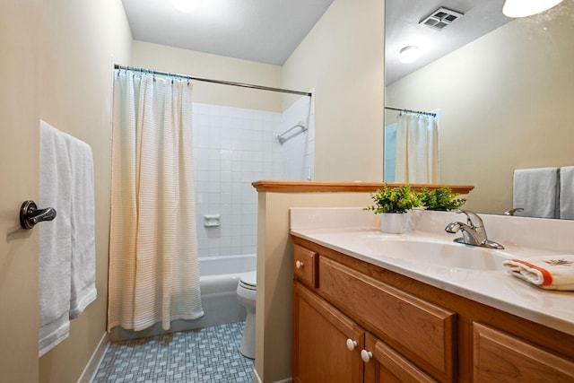 full bathroom featuring vanity, shower / bath combo with shower curtain, toilet, and tile patterned floors