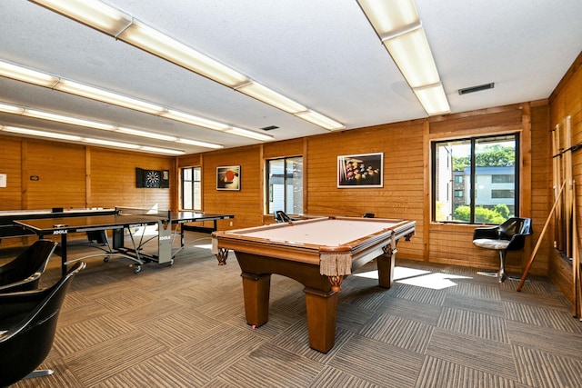 recreation room featuring carpet flooring, wooden walls, a textured ceiling, and billiards