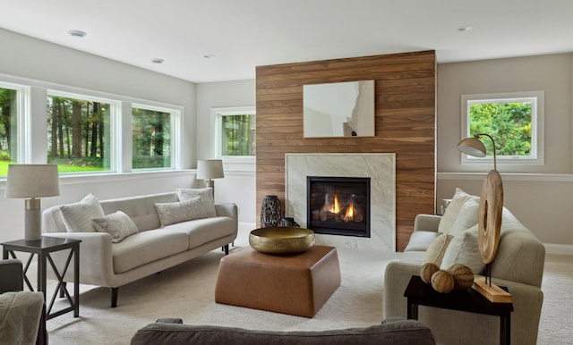 living room featuring light colored carpet and a premium fireplace