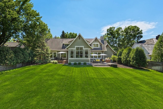 rear view of house with a yard and a patio