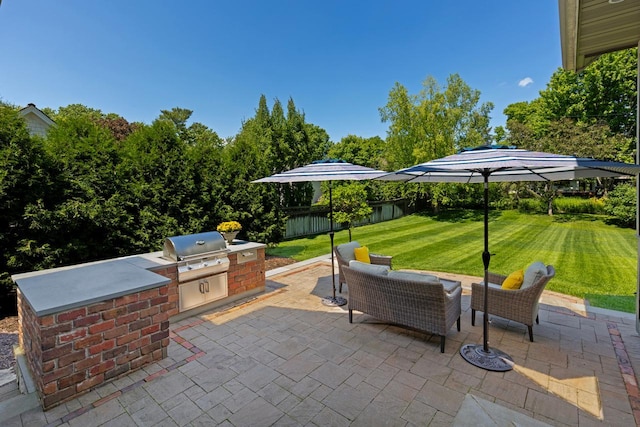 view of patio / terrace featuring exterior kitchen, a grill, and an outdoor hangout area