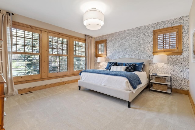 bedroom featuring light colored carpet