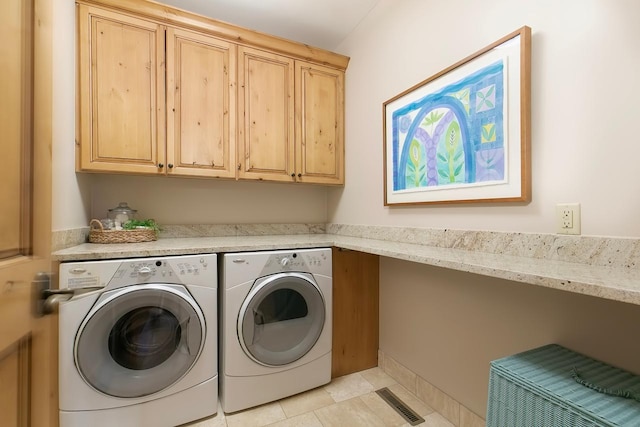 washroom featuring light tile patterned floors, cabinets, and separate washer and dryer