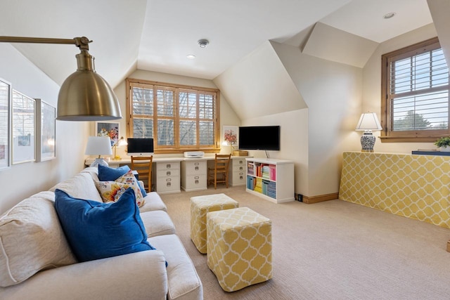 carpeted living room with built in desk and lofted ceiling