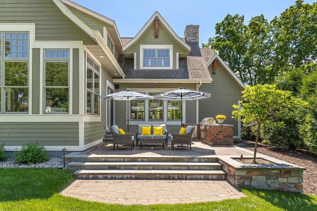 rear view of house with outdoor lounge area and a patio