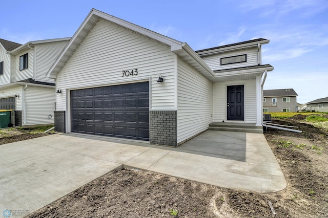 7043 Benji Ln, Fargo, ND 58047 - view of front facade with an attached garage, brick siding, and concrete driveway