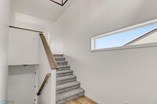 7043 Benji Ln, Fargo, ND 58047 - stairway with baseboards and wood finished floors