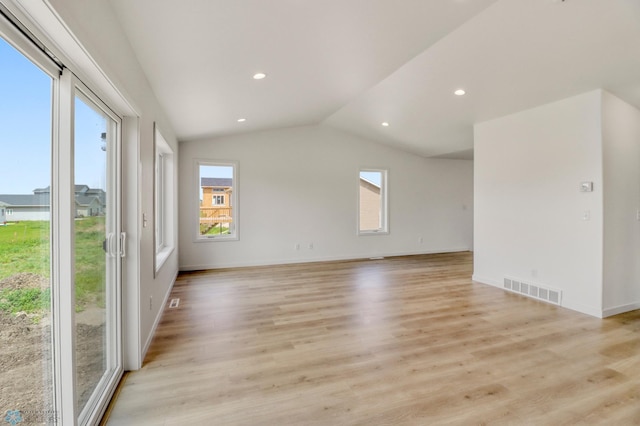 7043 Benji Ln, Fargo, ND 58047 - spare room with plenty of natural light, vaulted ceiling, light wood finished floors, recessed lighting, and baseboards