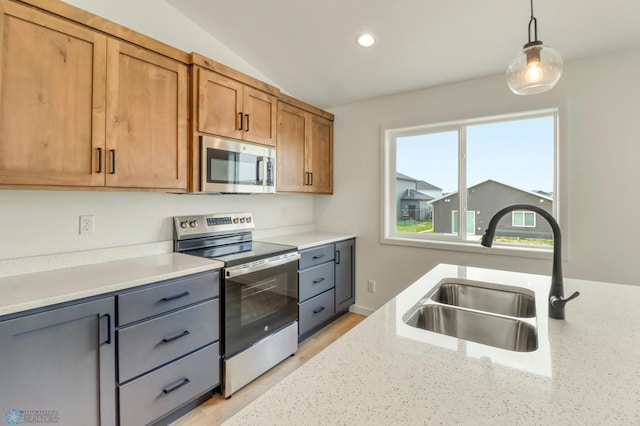 7043 Benji Ln, Fargo, ND 58047 - kitchen featuring stainless steel appliances, a sink, decorative light fixtures, recessed lighting, and brown cabinetry