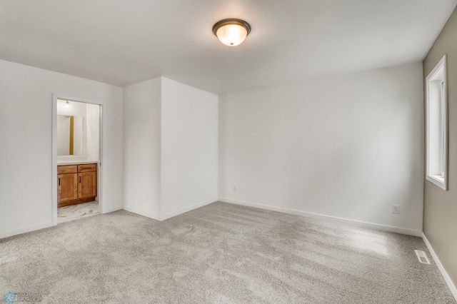7043 Benji Ln, Fargo, ND 58047 - empty room featuring light carpet and baseboards