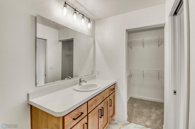 7043 Benji Ln, Fargo, ND 58047 - bathroom featuring vanity and a walk in closet