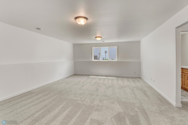 7043 Benji Ln, Fargo, ND 58047 - empty room featuring light colored carpet, baseboards, and a smoke detector