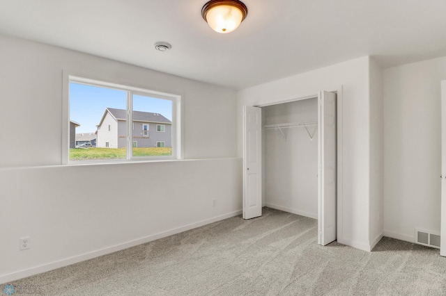 7043 Benji Ln, Fargo, ND 58047 - unfurnished bedroom with carpet, a closet, and baseboards