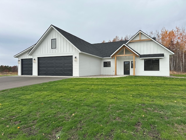 modern farmhouse style home featuring a front lawn and a garage