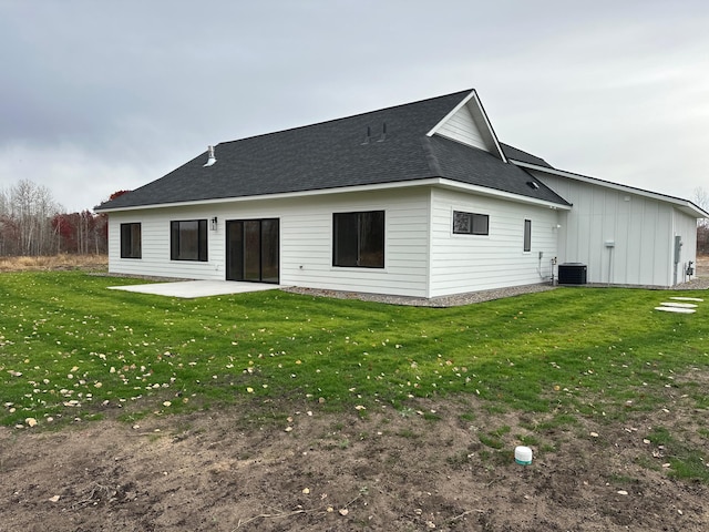 rear view of property featuring a patio, central AC, and a yard