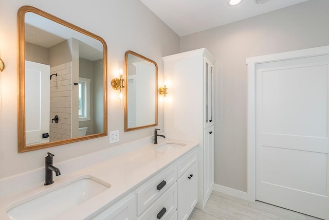 bathroom with vanity and tiled shower