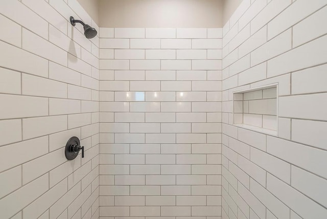 bathroom with a tile shower