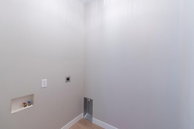 laundry area featuring electric dryer hookup, washer hookup, and light hardwood / wood-style floors