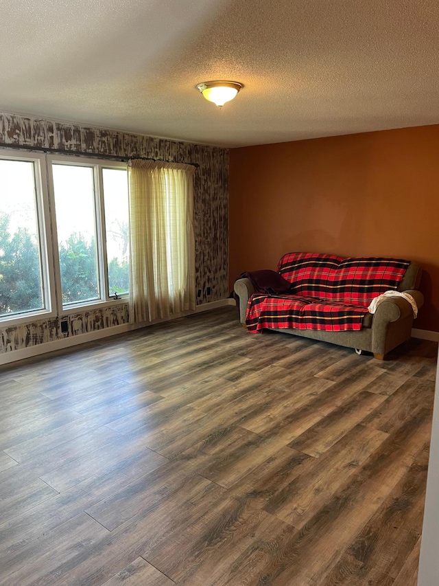 bedroom with a textured ceiling and wood-type flooring